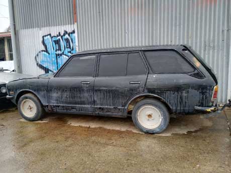 An old sedan parked in a Gold Coast driveway, ready for removal